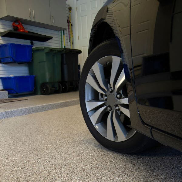 Car parked on flake finish epoxy garage floor by Epoxy Flooring Guys Melbourne, showing a clean, non-slip surface for everyday use.