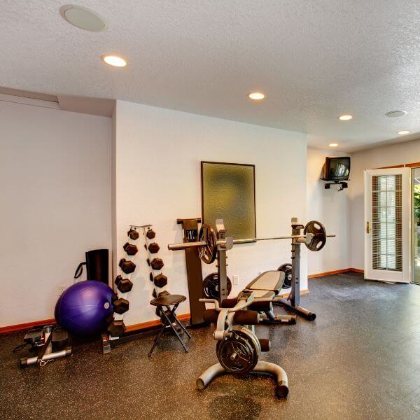 Home gym with durable epoxy flooring in Melbourne. Coating resists weights, sweat and equipment use.
